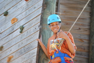 Austin Sunshine Camps Camper on the Ropes Course Smiling for a Photo