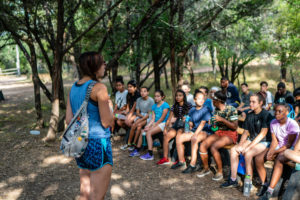 Campers listening to a camp counselor at Austin Sunshine Camps Lake Travis Summer Camp