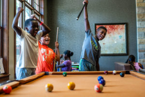 Austin Sunshine Camp campers playing a game of pool