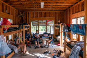 A group of Austin Sunshine Camp campers hanging out in the cabin during summer camp