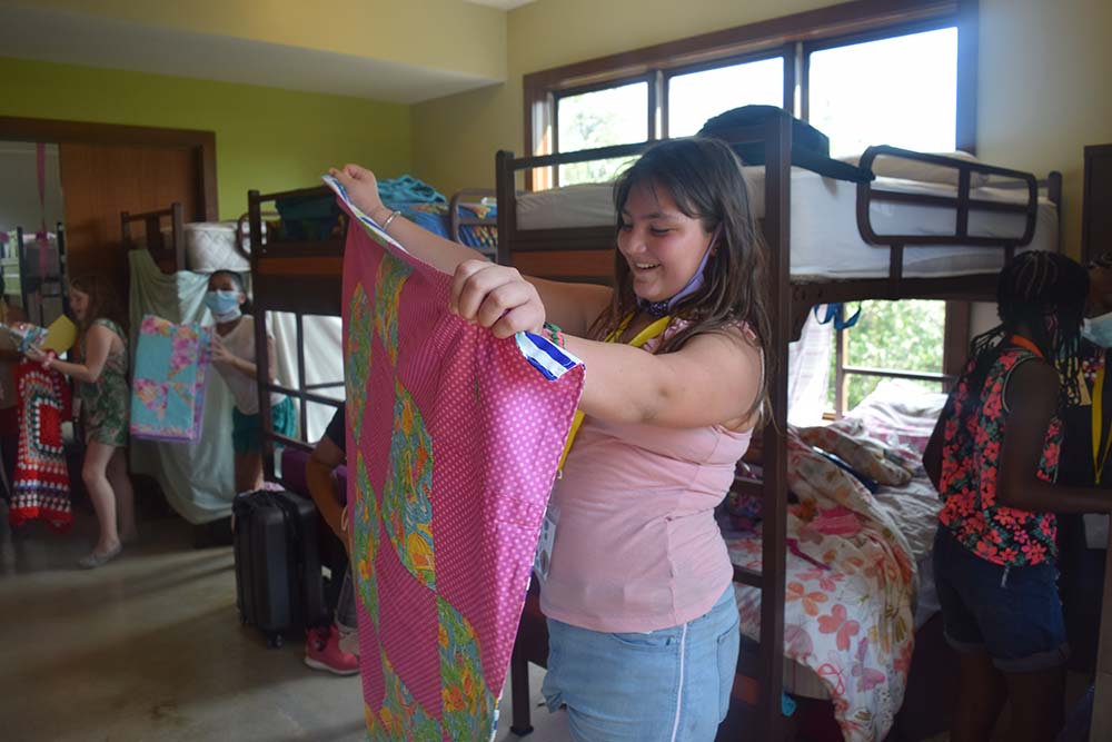 A camper folding her towel at Austin Sunshine Camps