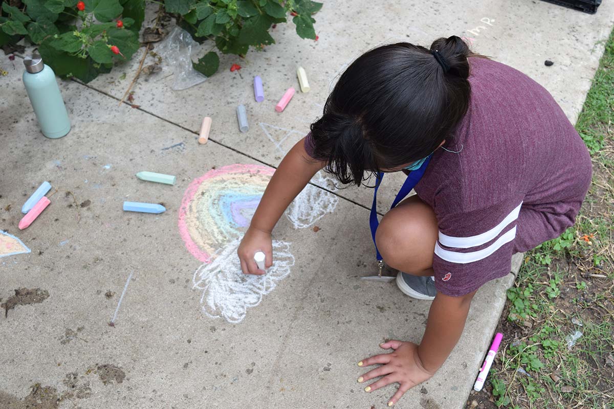Austin Sunshine Camps camper coloring with chalk